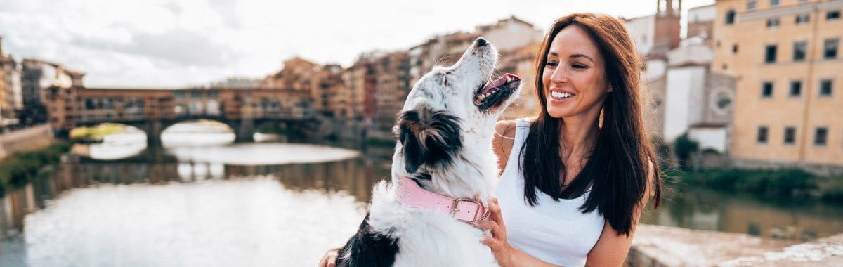 woman and dog on a bridge