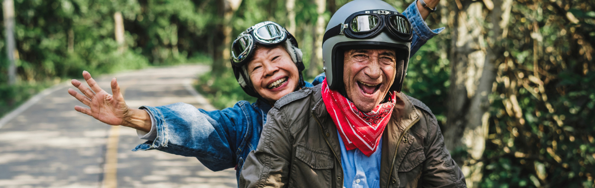 senior couple on scooter smiling 