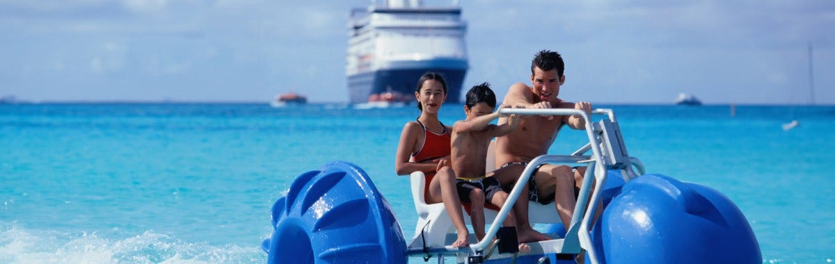 family on a water bike with a cruise ship behind them 