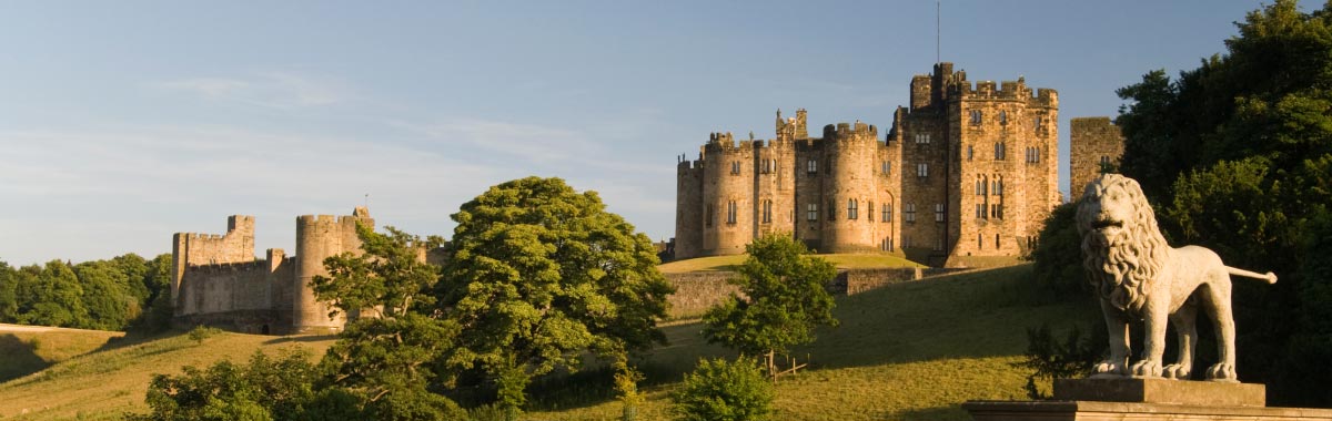 Alnwick Castle, Northumberland, with lion statue in foreground