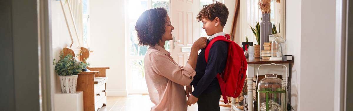 Mom helping her son get ready