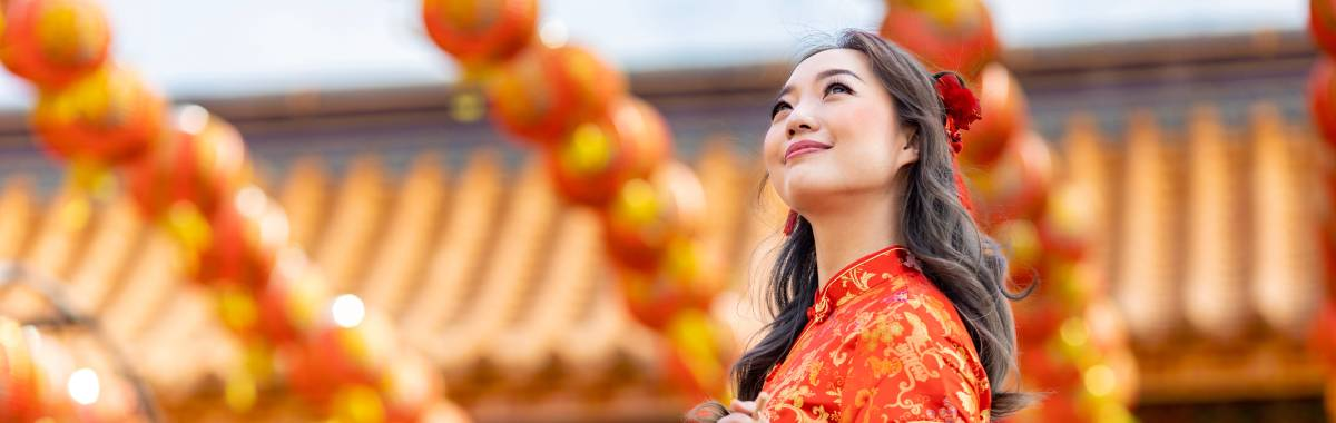 Woman in traditional Chinese garb walking through a festival
