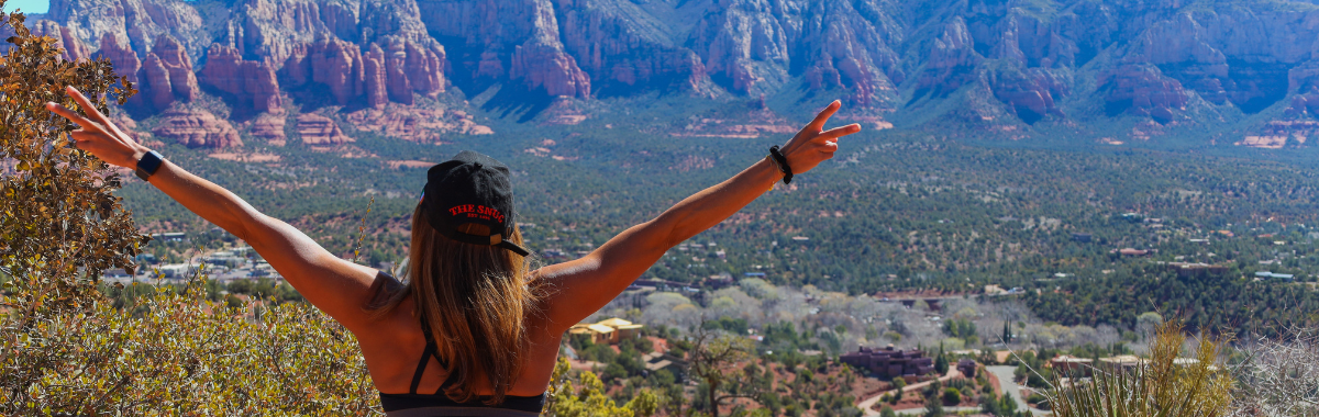 Woman overlooking sedona with arms wide open