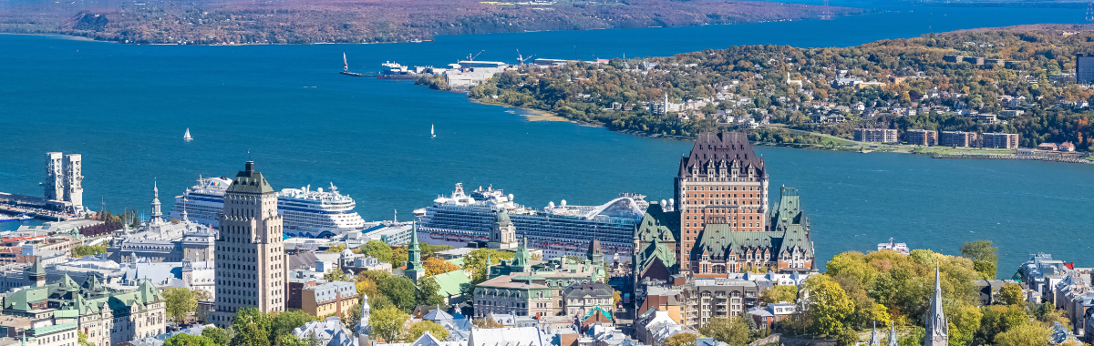 skyline shot of Quebec with cruise ships in the river