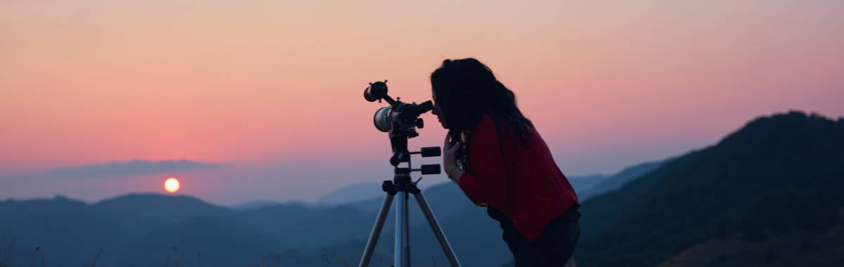 Woman looking through telescope