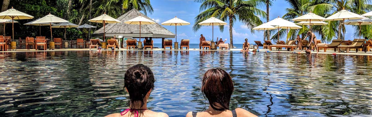 two women in a pool at a resort