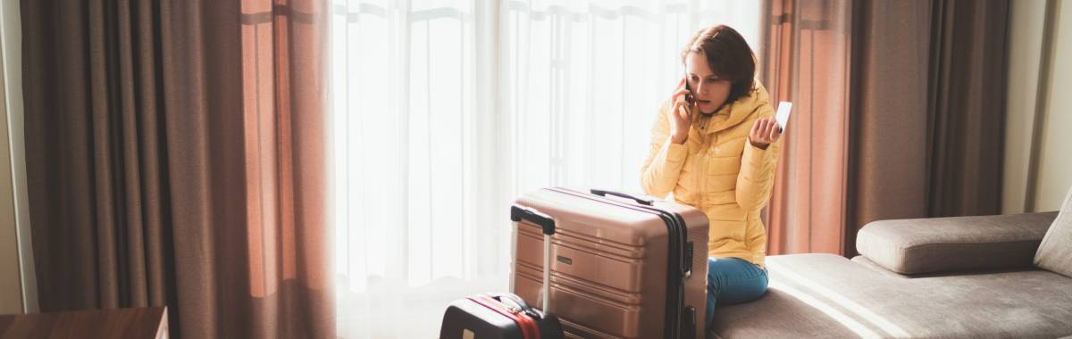 woman sitting in a hotel room on the phone