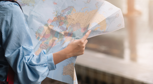 traveler using a paper map