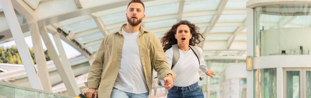 couple racing through airport to catch their flight