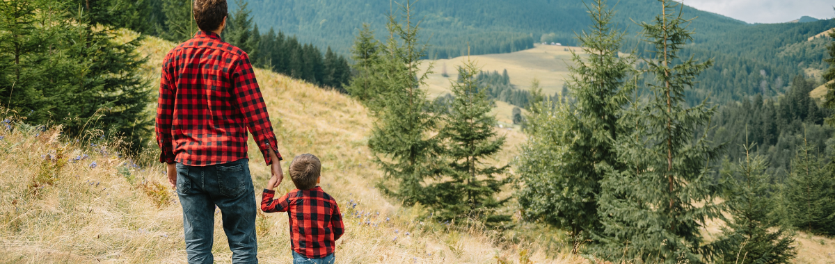 father and son looking out at wilderness