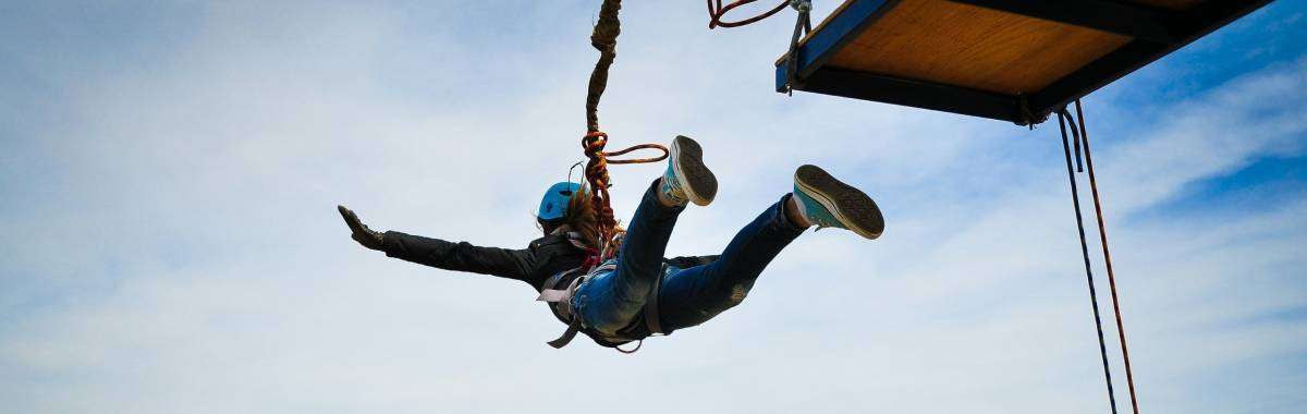 woman jumping off a platform bungee jumping