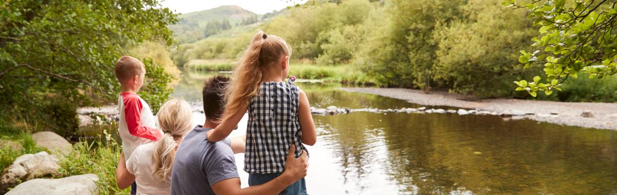 family looking at gentle river