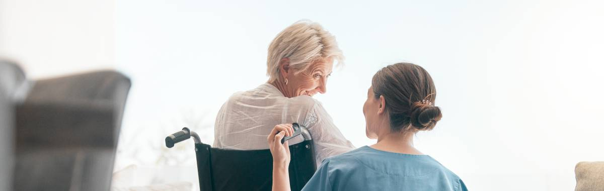 nurse checking on patient in a wheel chair