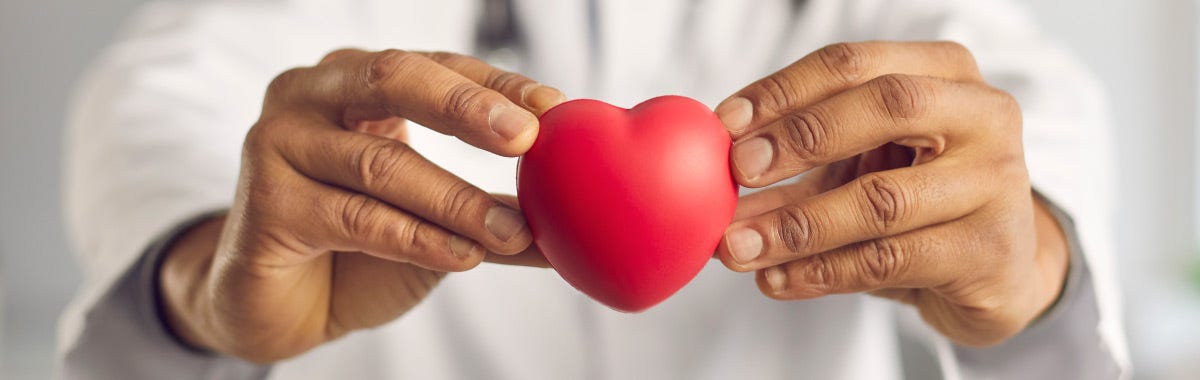 doctor holding red stress ball in shape of a heart