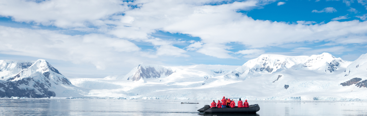 people in red coats in a small boat