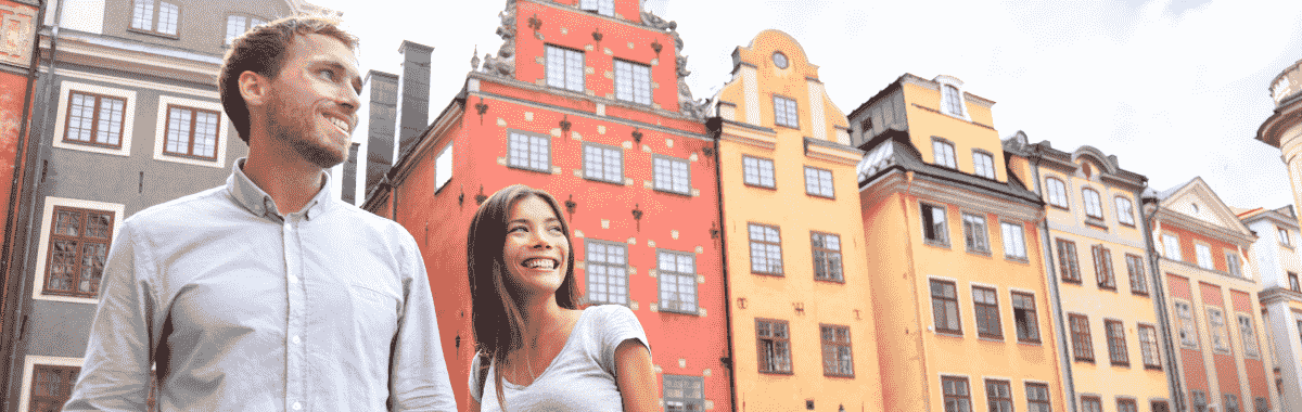couple together with buildings behind them