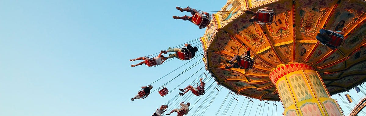 kids on a swing ride at a theme park