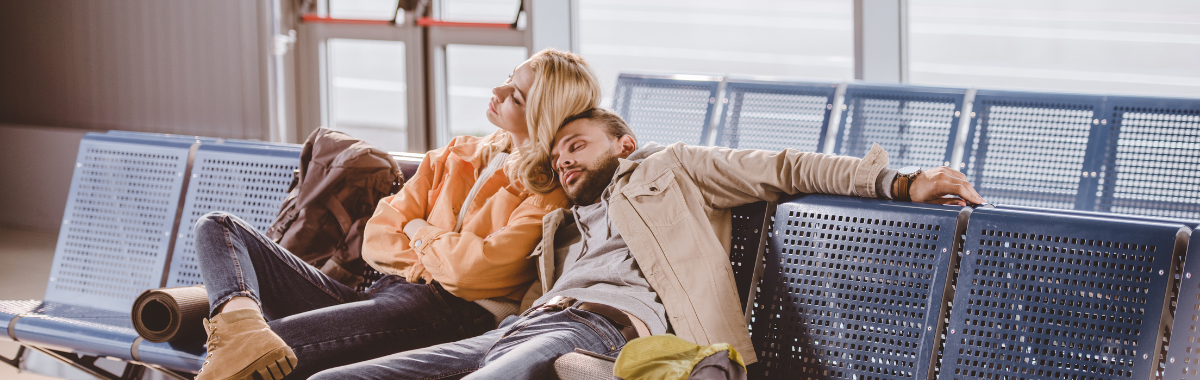 travelers sleeping on top of each other in an airport