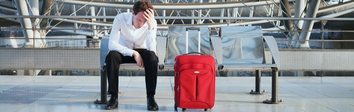 man sat on a bench looking sad