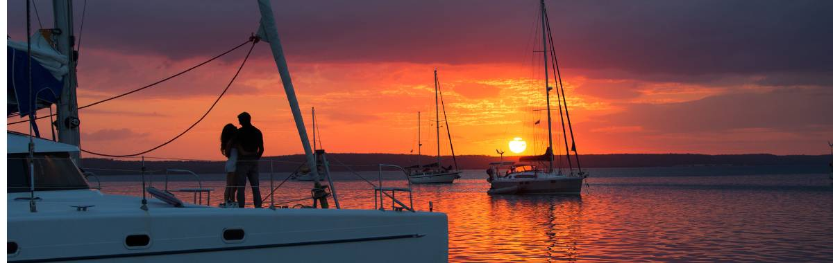 couple on a private boat at sunset