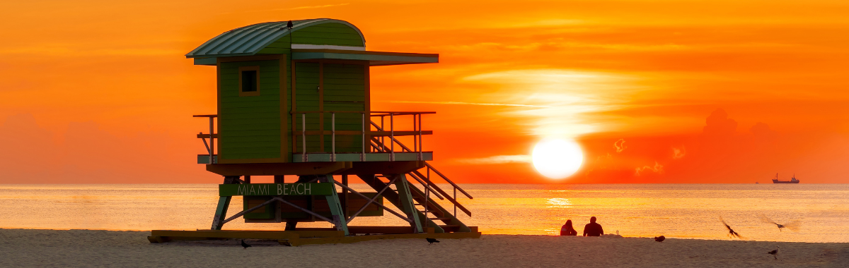 lifeguard shack on a beach at sunset