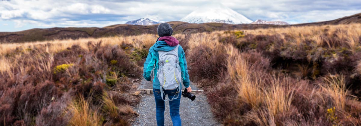 solo traveler in the shadow of a mountain in Tongariro National Park, New Zealand