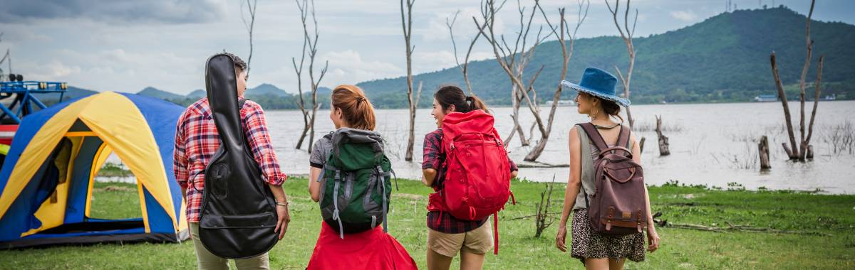 group of friends setting up for camping