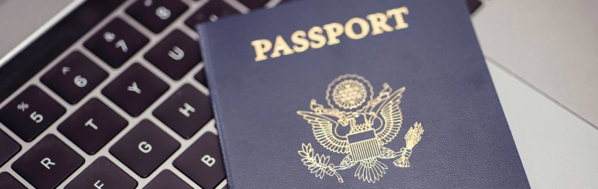 passport on top of laptop keyboard