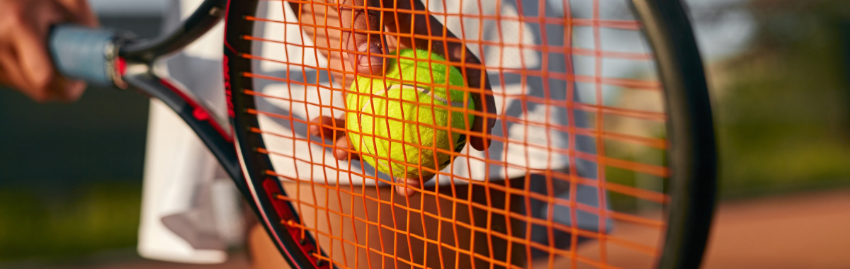 tennis racket with player ready to serve