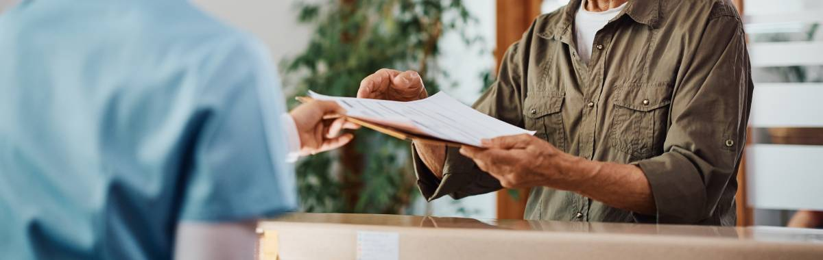 medical forms being passed to doctor