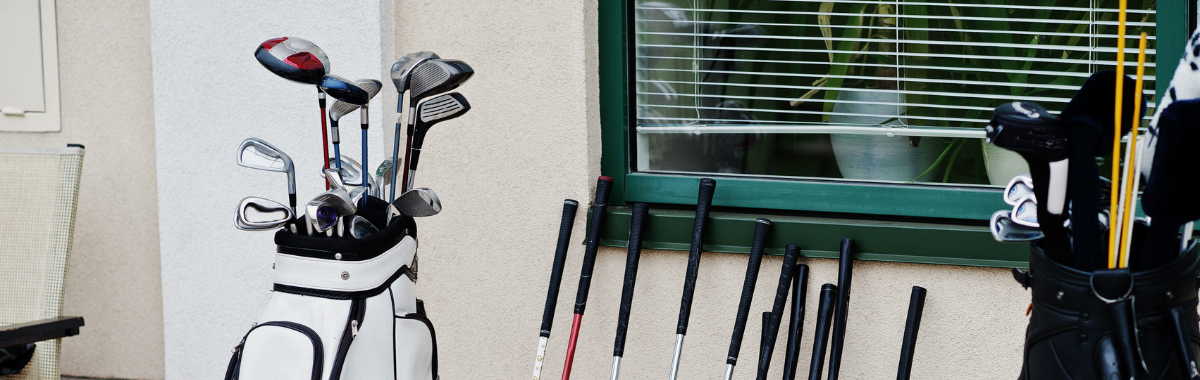 set of golf clubs sitting against wall