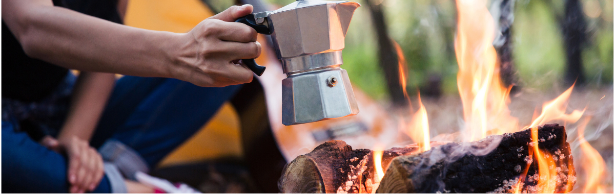 Coffee pot roasting over campfire