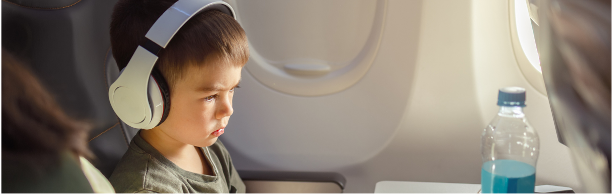 child on a flight wearing headphones 