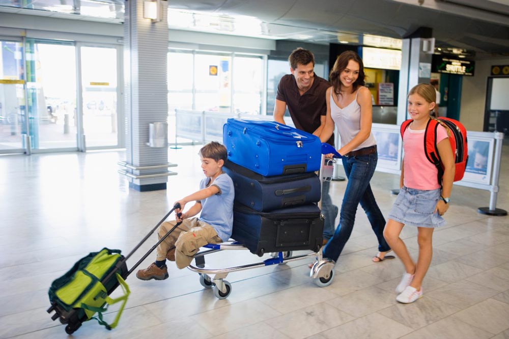 family in airport with many bags