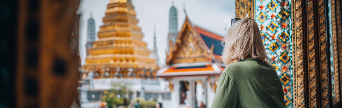 woman with beret looking at the Eiffel Tower in Paris, France