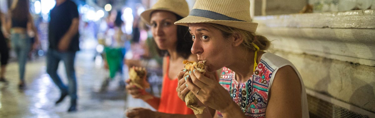 eating pita on the street in Greece