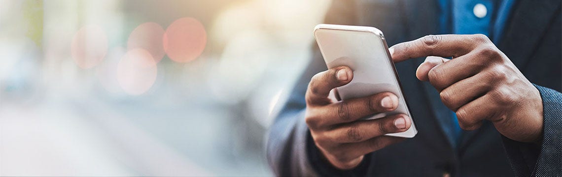 man using mobile phone to buy travel insurance