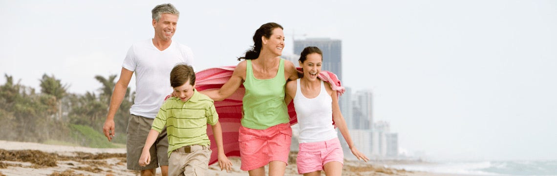 family walking on the beach together
