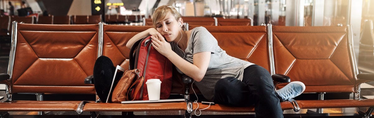 woman sleeping on airport seats