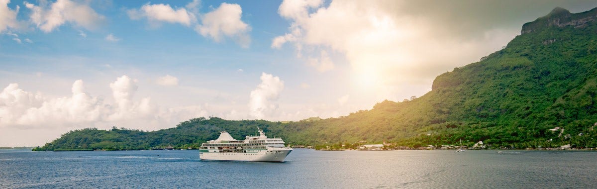 cruise ship coming into a bay in Tahiti