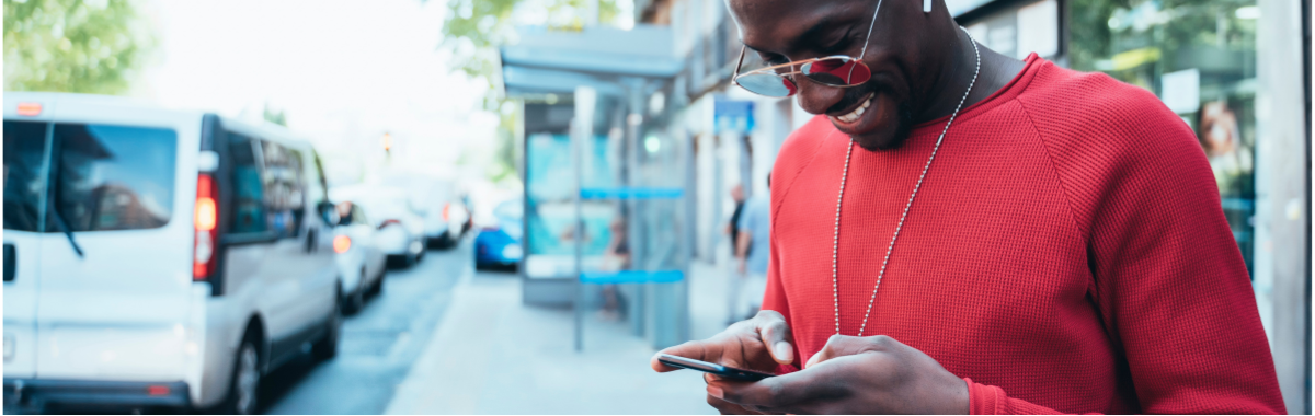 man typing on his phone happy