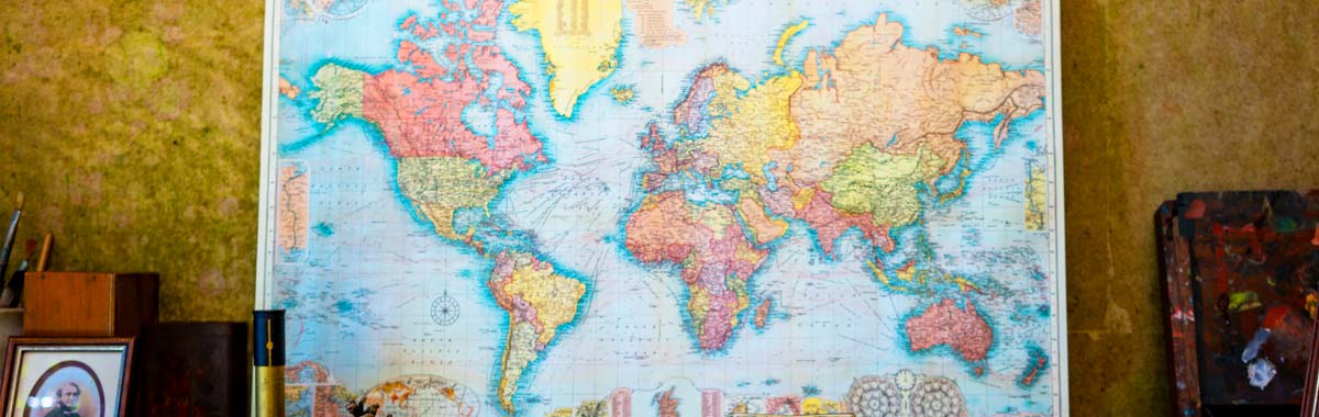 world map on wall showing most popular travel destinations for travel insurance