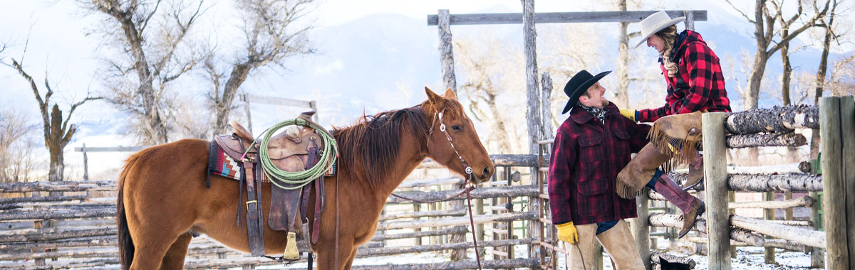 two people at a ranch vacation with a horse
