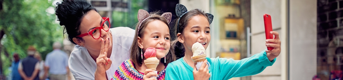 mom with kids and ice cream cones taking a selfie