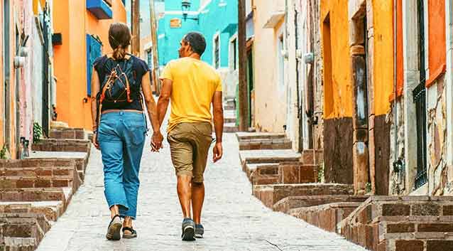 a couple holding hands on vacation