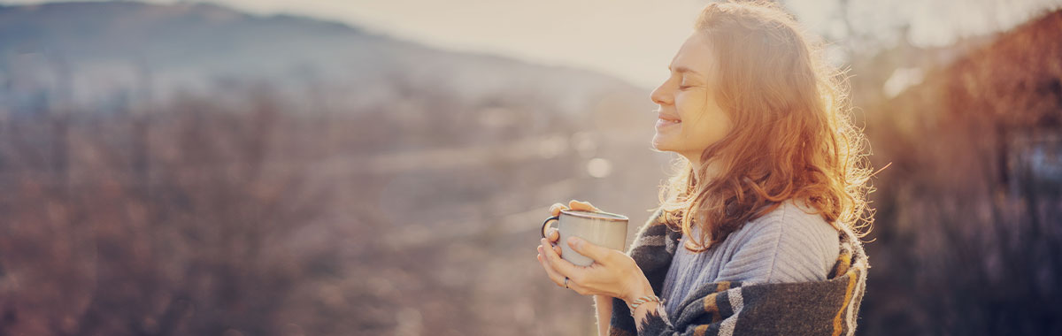person holding a cup of tea and taking a break