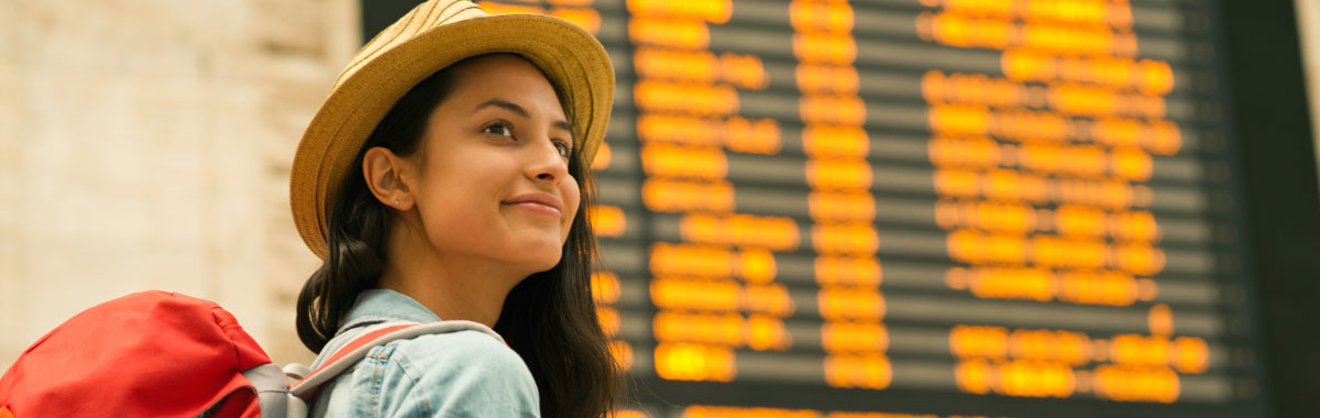 woman in front of airport sign