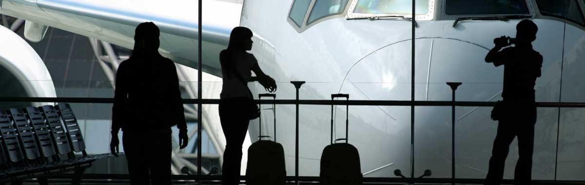 travelers in front of plane