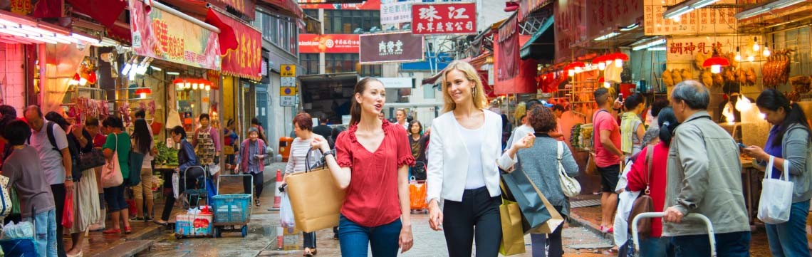 two people on the crowded streets of Hong Kong