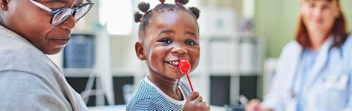 happy kid at the doctor office with candy